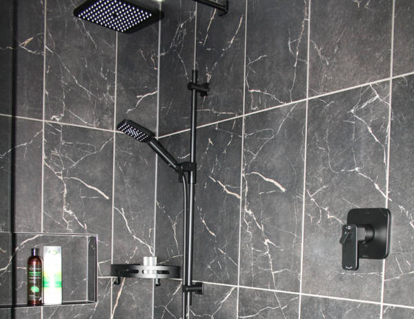 Built in niche and matte black rainfall showerhead and fixtures